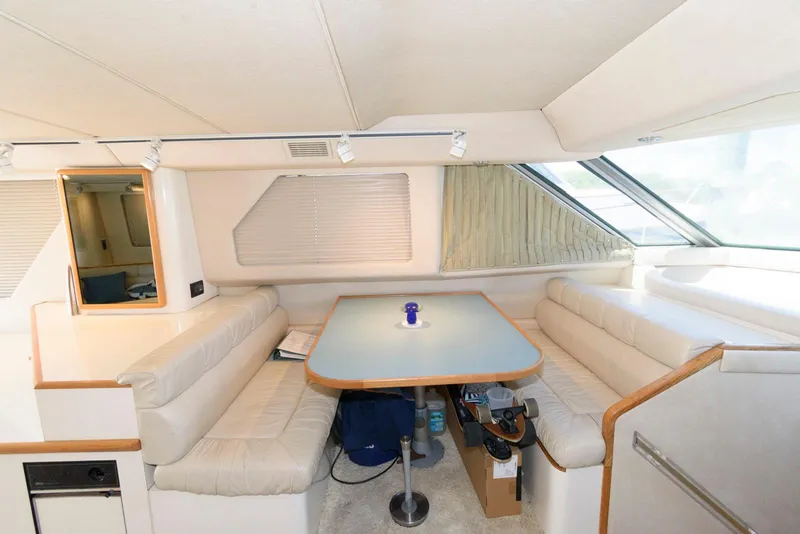 Slide: The Image of Interior of 1995 Sea Ray 500 Sedan Bridge with dining area and seating. - 19
