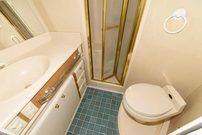 Slide: The Image of Bathroom interior of 1995 Sea Ray 500 Sedan Bridge with shower, sink, and toilet. - 22