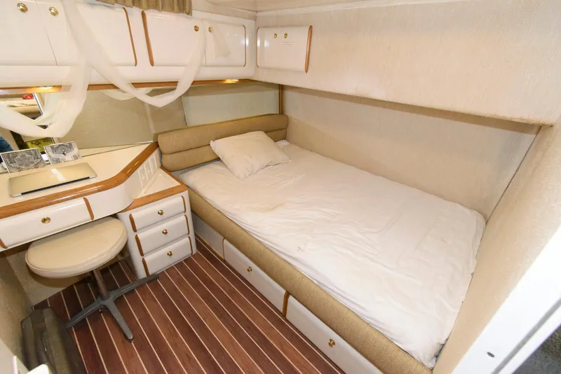 Slide: The Image of Cozy cabin interior of 1995 Sea Ray 500 Sedan Bridge with bed and desk. - 23