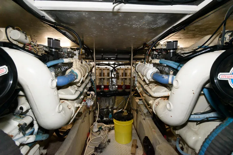 Slide: The Image of Engine room of a 1995 Sea Ray 500 Sedan Bridge with dual engines and maintenance equipment. - 26