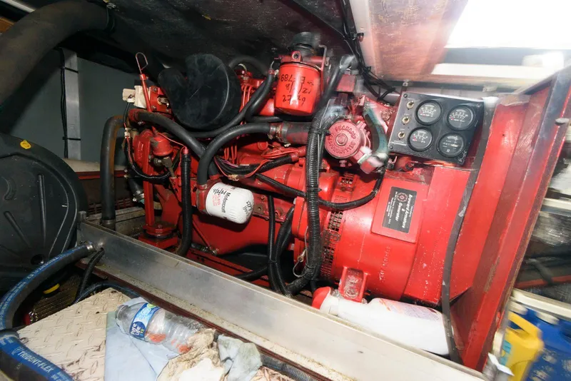 Slide: The Image of Engine room of 1995 Sea Ray 500 Sedan Bridge with red machinery and control panel. - 27