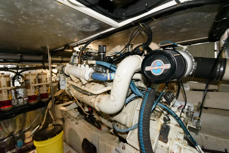 Slide: The Image of Engine room of a 1995 Sea Ray 500 Sedan Bridge, showcasing complex machinery and components. - 28