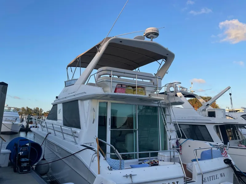Slide: The Image of 1995 Sea Ray 500 Sedan Bridge yacht docked at marina under clear blue sky. - 4