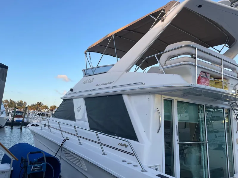 Slide: The Image of 1995 Sea Ray 500 Sedan Bridge yacht docked at marina, side view. - 5