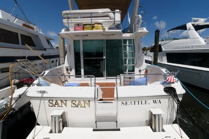 Slide: The Image of 1995 Sea Ray 500 Sedan Bridge yacht docked, rear view, named "San San" from Seattle, WA. - 8