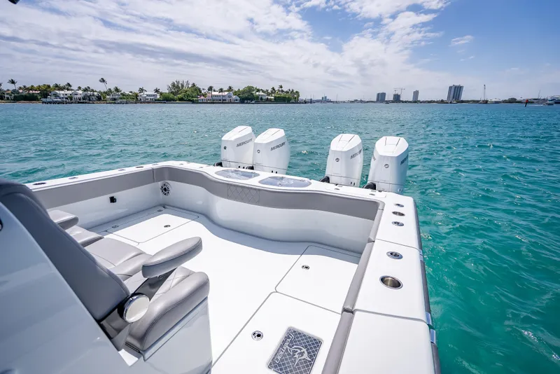 Slide: The Image of 2024 Freeman 43 boat with four engines on clear blue water. - 19