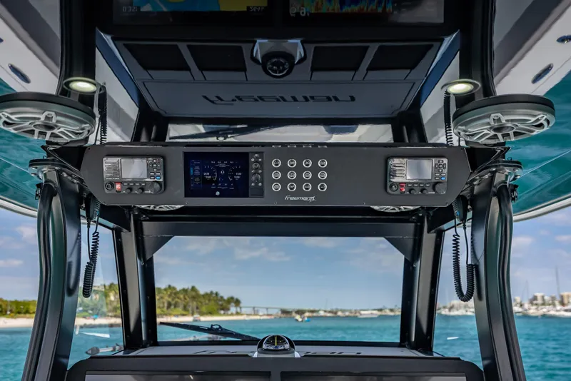 Slide: The Image of 2024 Freeman 43 boat dashboard with advanced controls, cruising on clear blue waters. - 25
