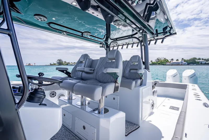 Slide: The Image of 2024 Freeman 43 boat interior with luxurious seating and modern controls on a sunny day. - 27
