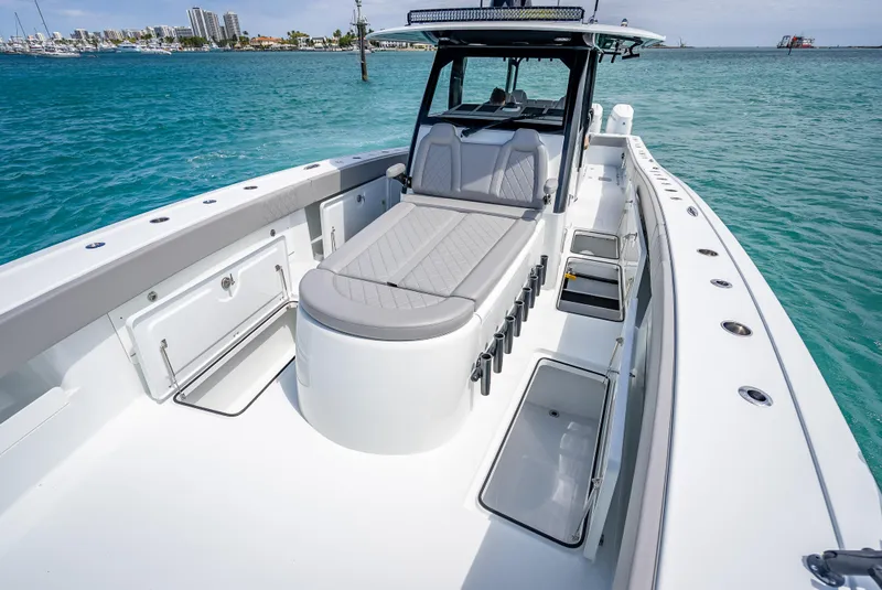 Slide: The Image of 2024 Freeman 43 boat with spacious deck and seating on clear blue water. - 35