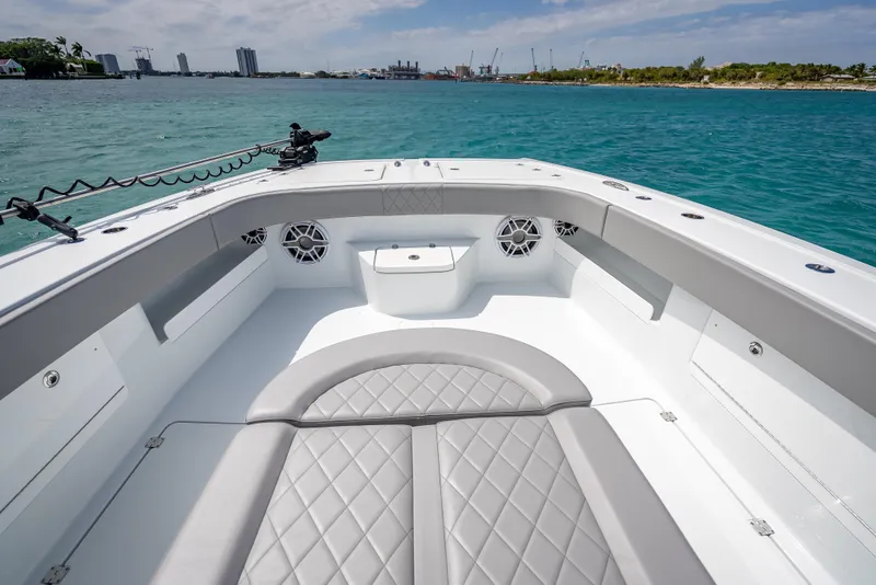 Slide: The Image of Luxurious 2024 Freeman 43 boat interior with quilted seating, on a serene blue water backdrop. - 39