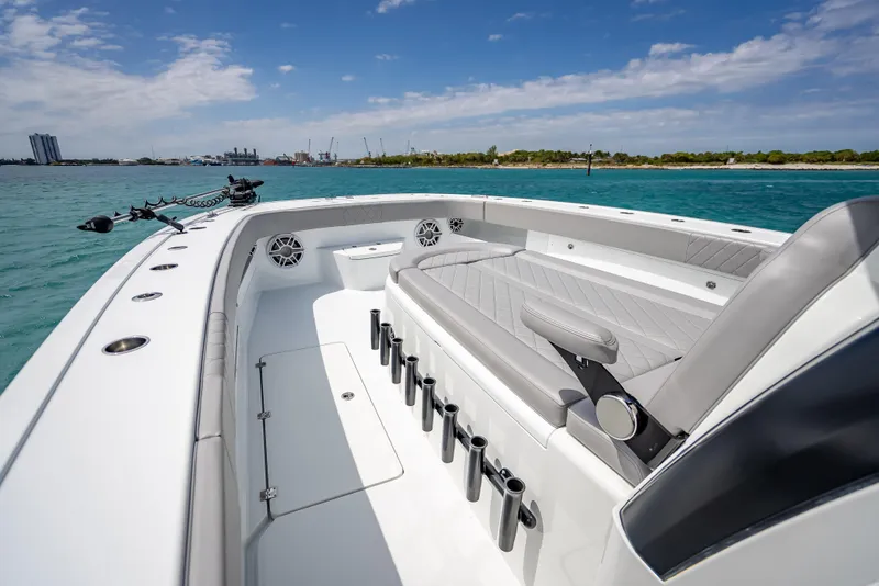 Slide: The Image of 2024 Freeman 43 boat interior with seating and rod holders on a sunny day. - 40