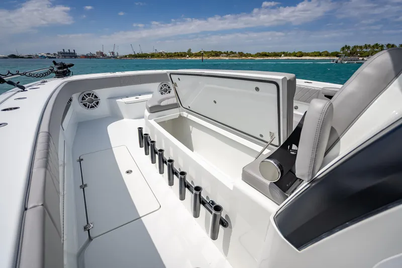 Slide: The Image of 2024 Freeman 43 boat interior with open storage, rod holders, and ocean view. - 42