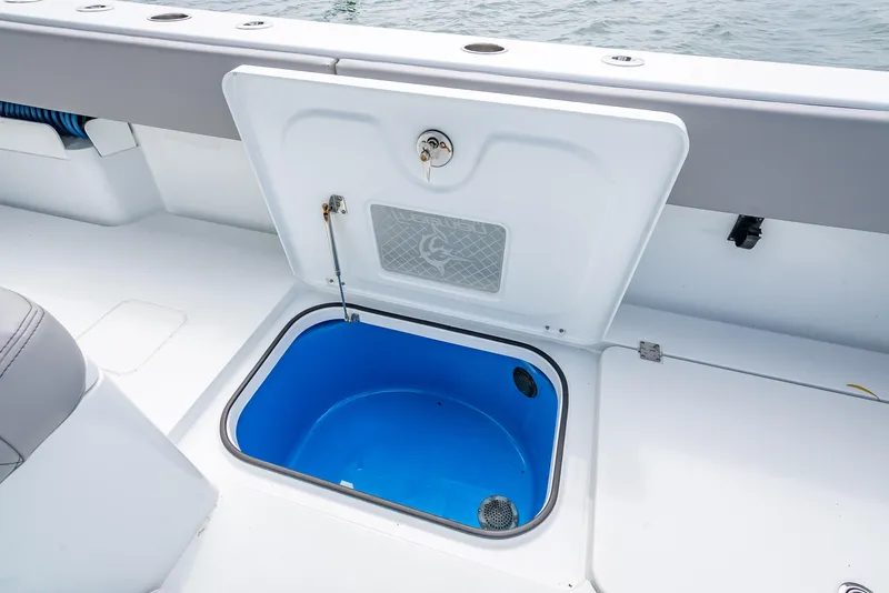 Slide: The Image of Open storage compartment on 2024 Freeman 43 boat, featuring a blue interior. - 45