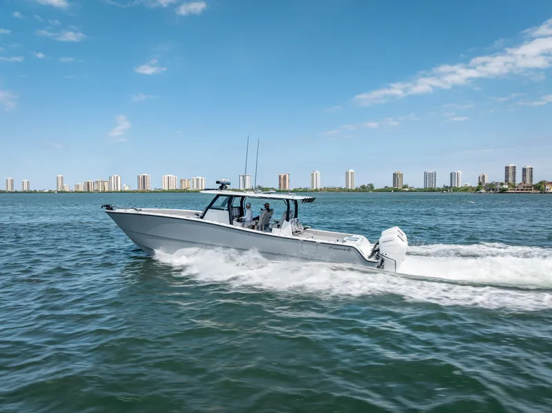 Slide: The Image of 2024 Freeman 43 boat cruising on water with city skyline in background. - 9