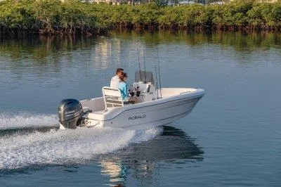 Slide: The Image of 2025 Robalo R160 Center Console boat cruising on calm water. - 10