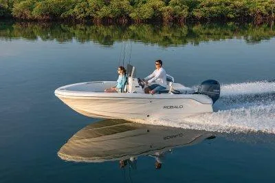 Slide: The Image of 2025 Robalo R160 Center Console boat cruising on calm water. - 13