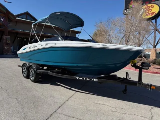 Slide: The Image of 2025 Tahoe 210 S boat on trailer, parked outdoors with canopy. - 0