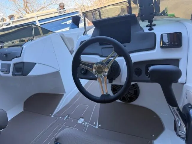 Slide: The Image of 2025 Tahoe 210 S boat interior with steering wheel and dashboard controls. - 5