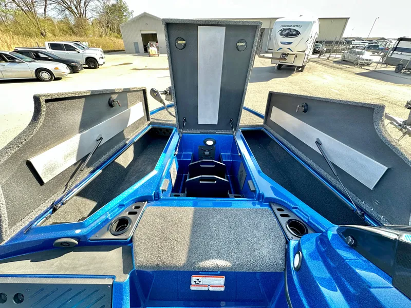 Slide: The Image of 2025 Nitro Z19 boat interior with blue accents in a parking lot. - 10
