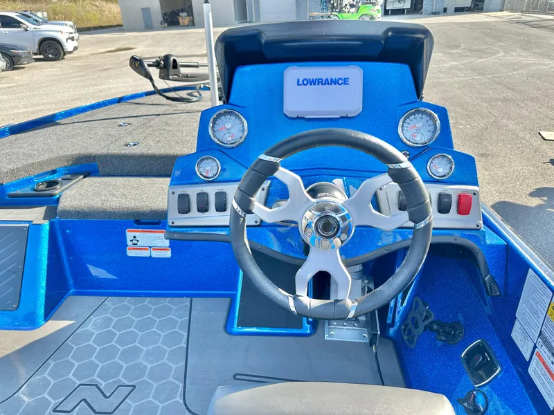 Slide: The Image of 2025 Nitro Z19 boat deck in a parking lot with vehicles and buildings. - 11