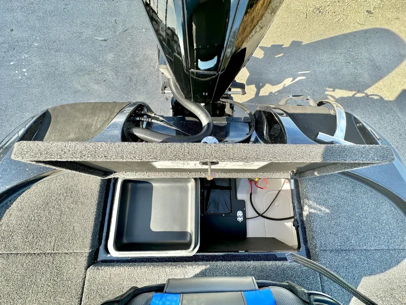 Slide: The Image of 2025 Nitro Z19 boat storage compartment with open lid, featuring cup holders and storage bins. - 15