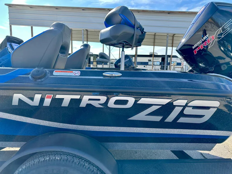 Slide: The Image of 2025 Nitro Z19 boat with sleek design, parked outdoors under a clear sky. - 2
