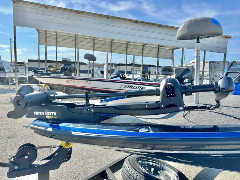 Slide: The Image of 2025 Nitro Z19 boat on trailer, parked outdoors under clear blue sky. - 6