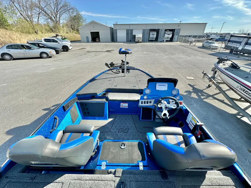 Slide: The Image of 2025 Nitro Z19 boat with Minn Kota Maxxum trolling motor in a marina setting. - 8