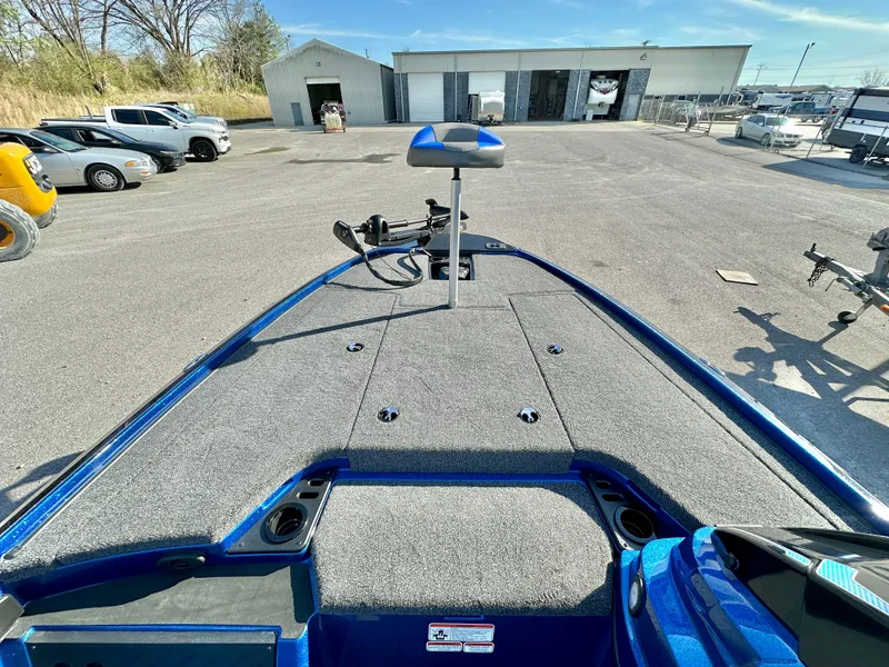 Slide: The Image of 2025 Nitro Z19 boat with blue interior, parked in a lot near a warehouse. - 9