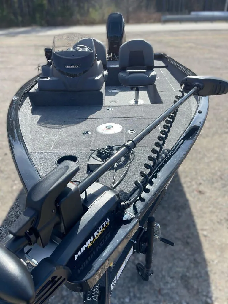 Slide: The Image of 2025 Tracker Super Guide V-16 SC fishing boat with Minn Kota motor, viewed from the bow. - 3