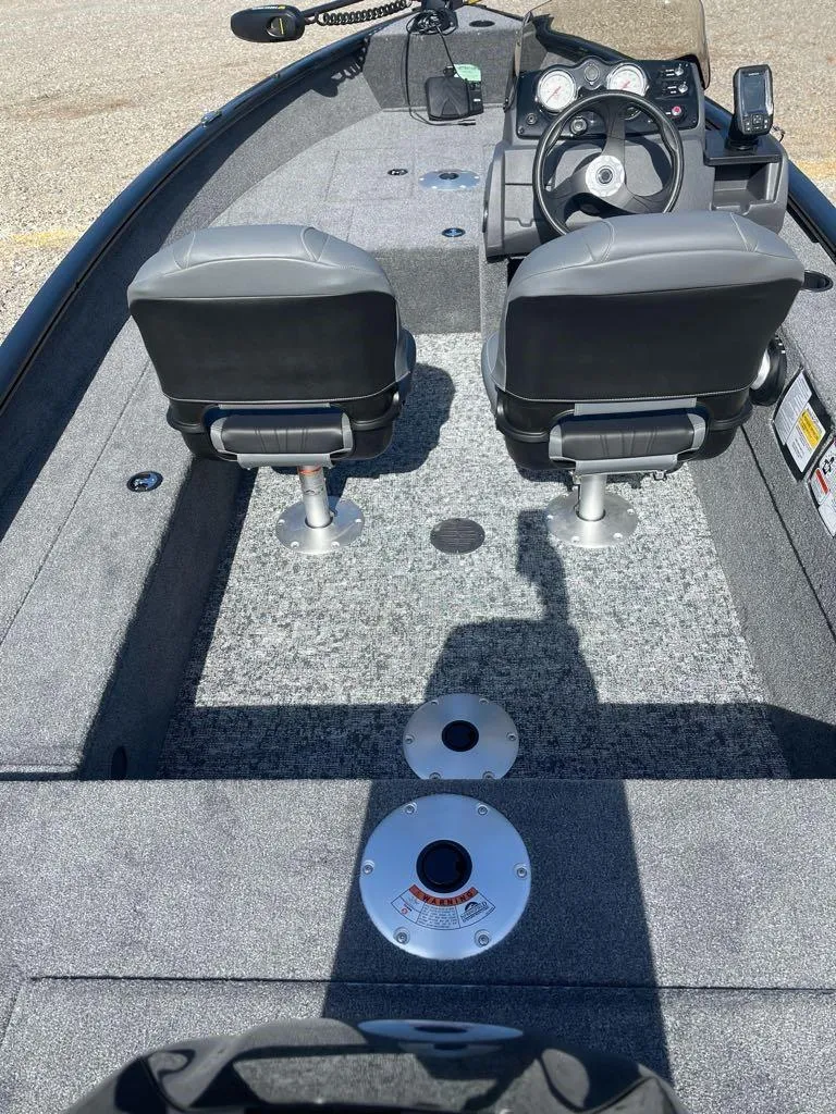 Slide: The Image of 2025 Tracker Super Guide V-16 SC boat interior with dual seats and steering console. - 4