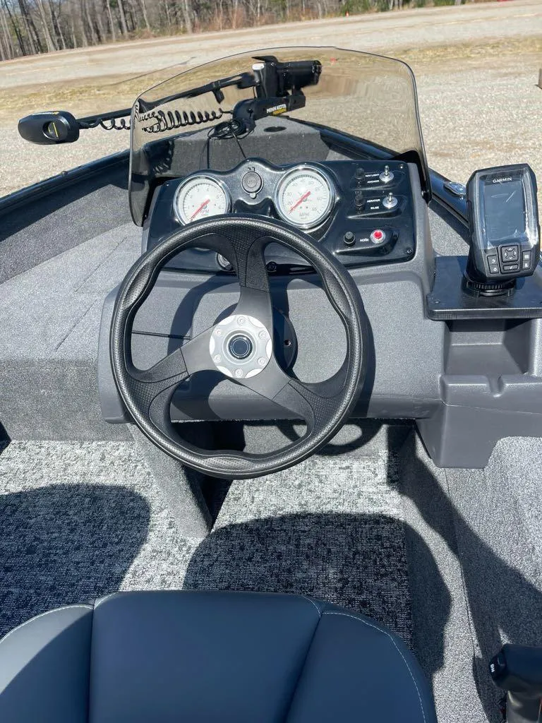 Slide: The Image of 2025 Tracker Super Guide V-16 SC boat dashboard with steering wheel and gauges. - 5