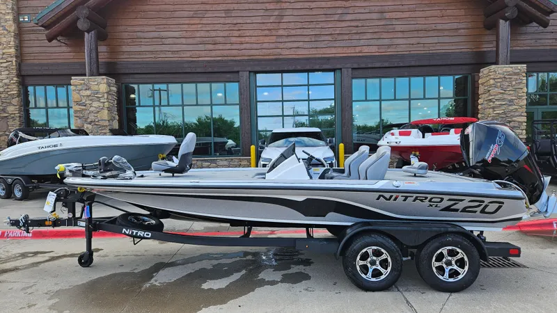 The Image of 2025 Nitro Z20 XL boat on trailer, parked outside a building. - 0