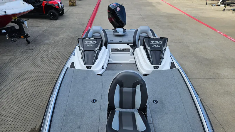 Slide: The Image of 2025 Nitro Z20 XL boat with dual seats and motor, parked on concrete surface. - 5