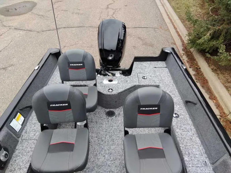 Slide: The Image of 2025 Tracker Pro Guide V-16 WT boat interior with four seats and motor. - 4