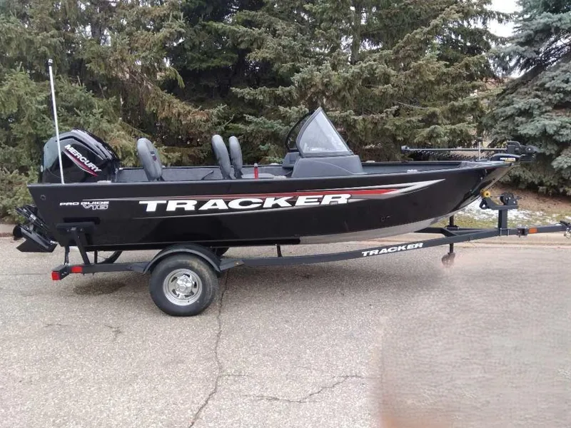 Slide: The Image of 2025 Tracker Pro Guide V-16 WT boat on trailer, parked outdoors. - 6