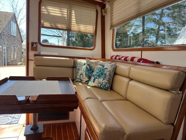Slide: The Image of Interior of 1996 Legacy Yachts 40 with beige seating and decorative pillows. - 13