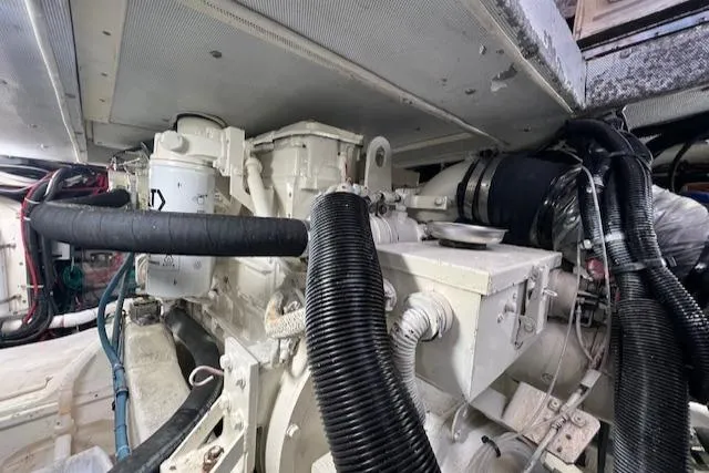 Slide: The Image of Engine room of a 1996 Legacy Yachts 40, showcasing mechanical components and hoses. - 17