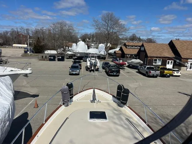 Slide: The Image of 1996 Legacy Yachts 40 in a marina parking lot with cars and buildings. - 19