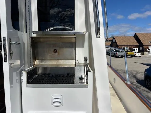 Slide: The Image of Outdoor grill on 1996 Legacy Yachts 40, docked with clear sky and buildings in background. - 22