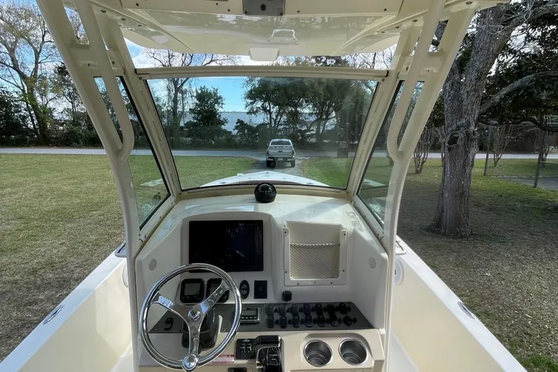 Slide: The Image of 2015 Scout 251 XS boat dashboard with steering wheel and control panel. - 12