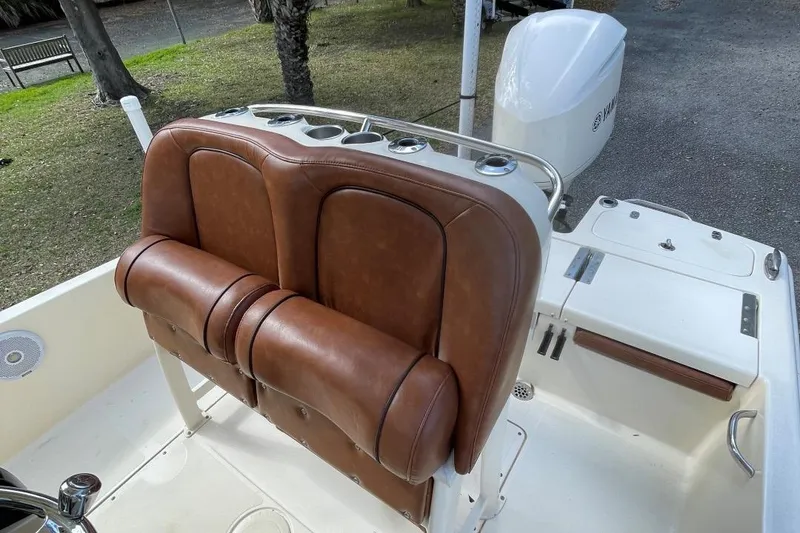 Slide: The Image of 2015 Scout 251 XS boat with brown leather seating and white deck. - 13