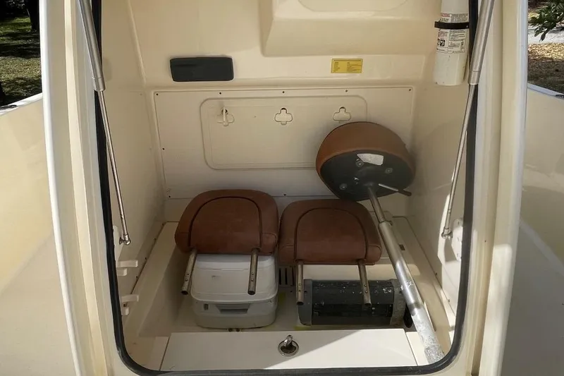Slide: The Image of 2015 Scout 251 XS boat interior storage compartment with seats and equipment. - 22
