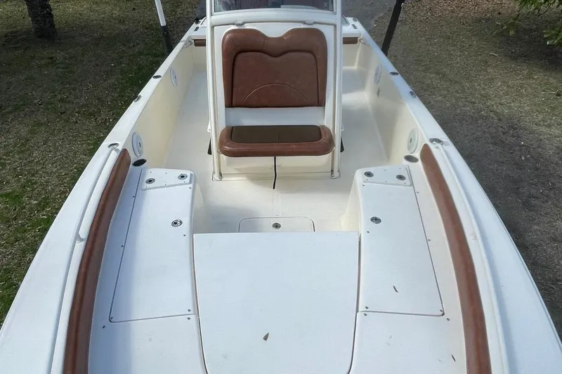 Slide: The Image of 2015 Scout 251 XS boat interior with brown and white seating and storage compartments. - 9