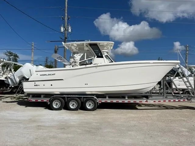 The Image of 2025 World Cat 280 CC-X boat on trailer under clear blue sky. - 1