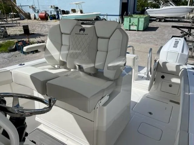 Slide: The Image of 2025 World Cat 280 CC-X boat interior with plush seating and steering wheel. - 5