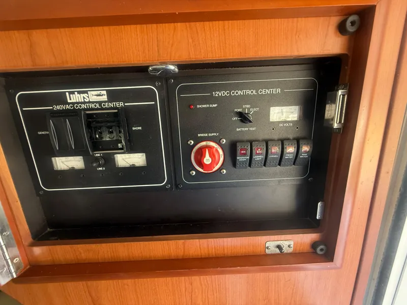 Slide: The Image of Control panel of a 2008 Luhrs 35 Convertible boat, featuring AC and DC switches. - 14