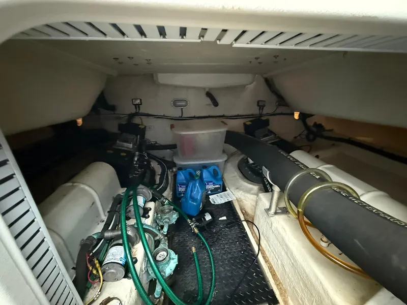 Slide: The Image of Engine compartment of 2008 Luhrs 35 Convertible boat, showing hoses and equipment. - 19