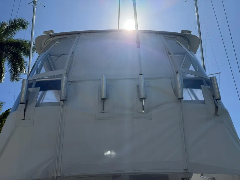 Slide: The Image of 2008 Luhrs 35 Convertible boat with sunlit bridge and palm trees in the background. - 27