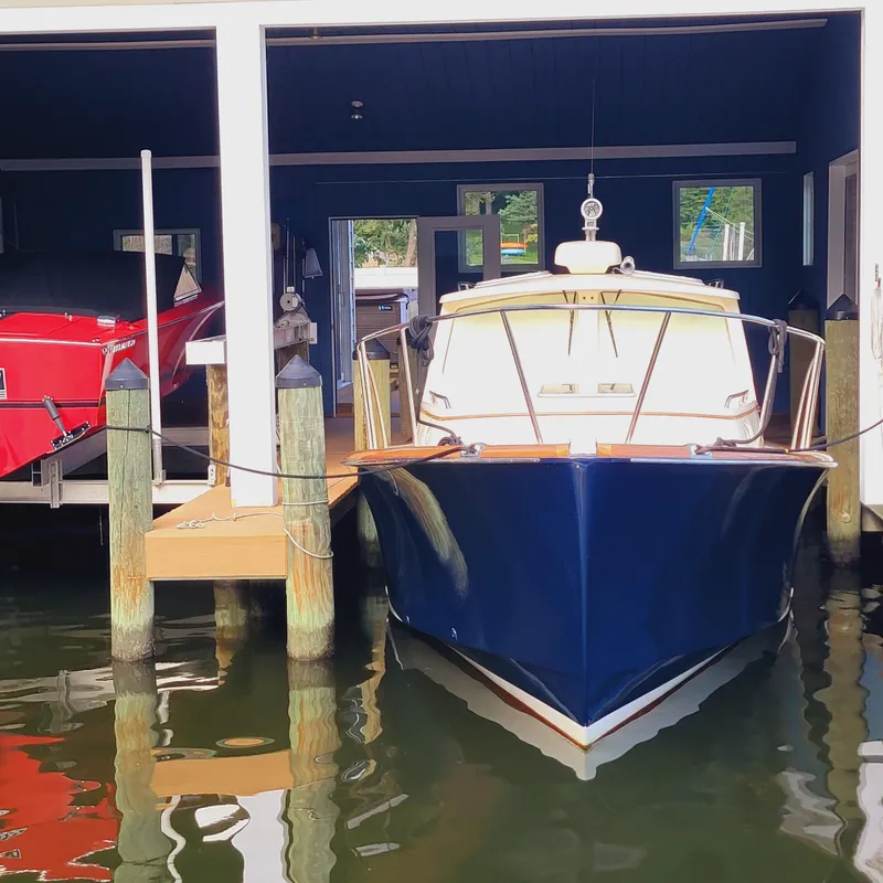 Slide: The Image of 1999 Hinckley Picnic Boat Classic docked in a boathouse. - 0